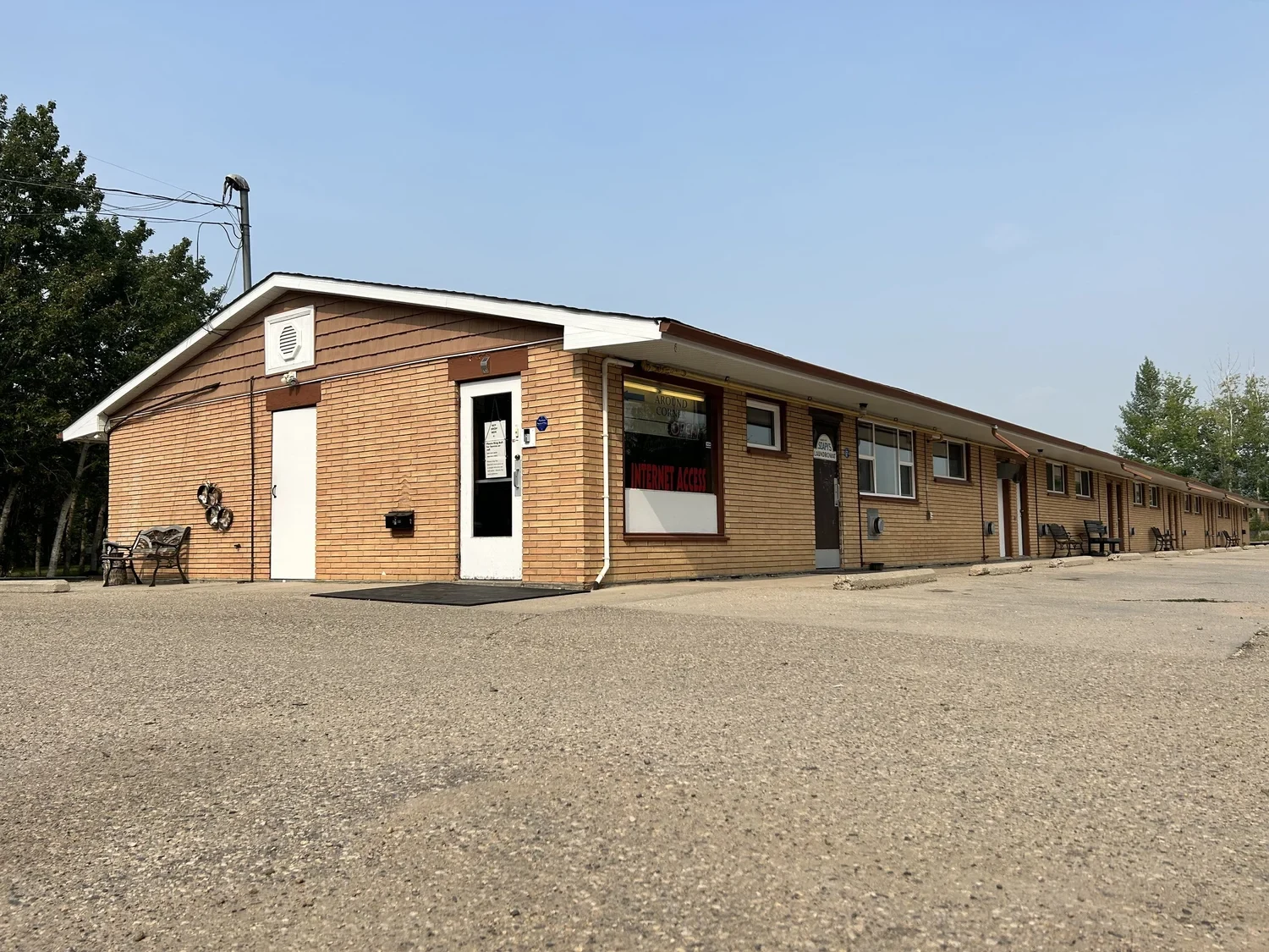 Duck Mountain Motel exterior with brick facade and guest room entrances